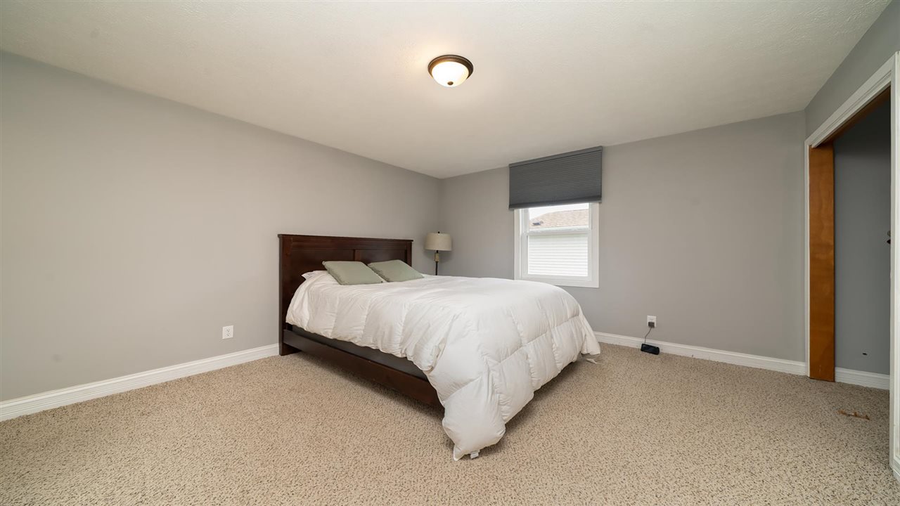 310 Pembroke Road Southwest Poplar Grove, IL 61065 - Photo 16 of 27 a bed sitting in a bedroom next to a window