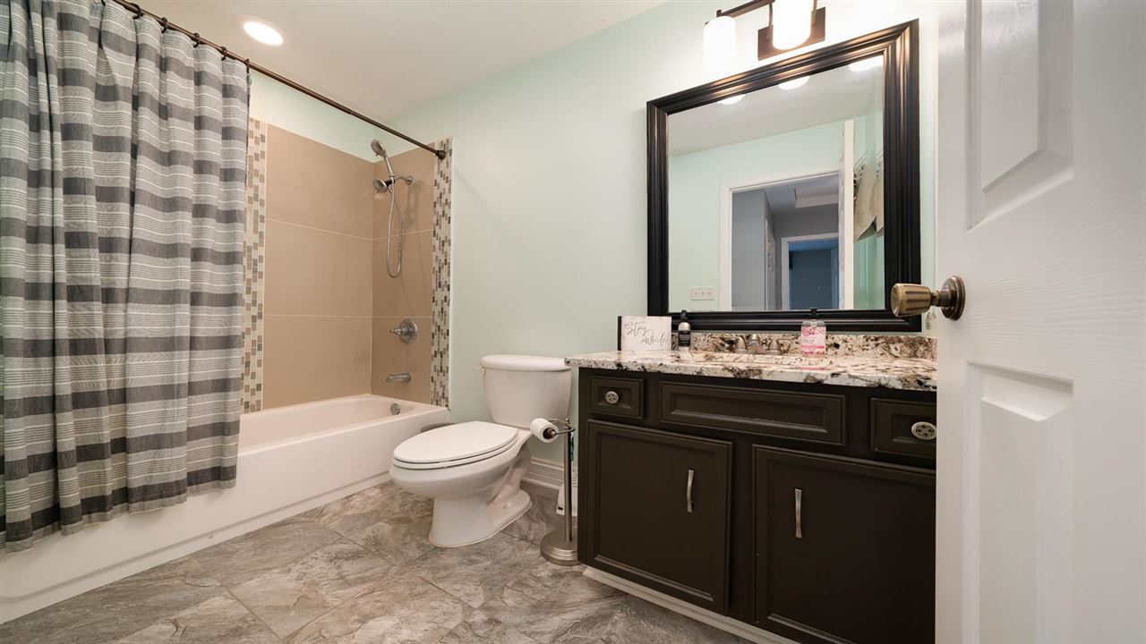 310 Pembroke Road Southwest Poplar Grove, IL 61065 - Photo 18 of 27 a bathroom with a sink a toilet a mirror and shower