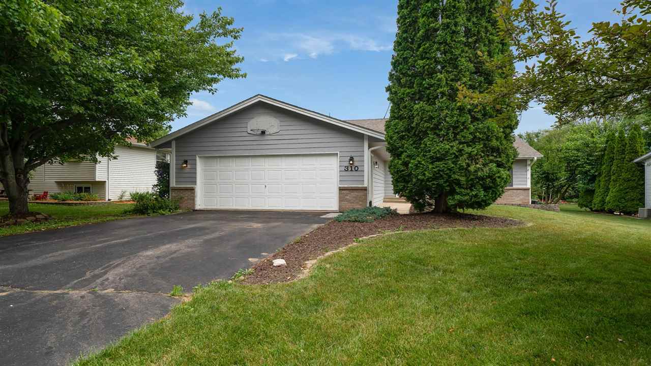 310 Pembroke Road Southwest Poplar Grove, IL 61065 - Photo 2 of 27 a front view of a house with a yard and garage