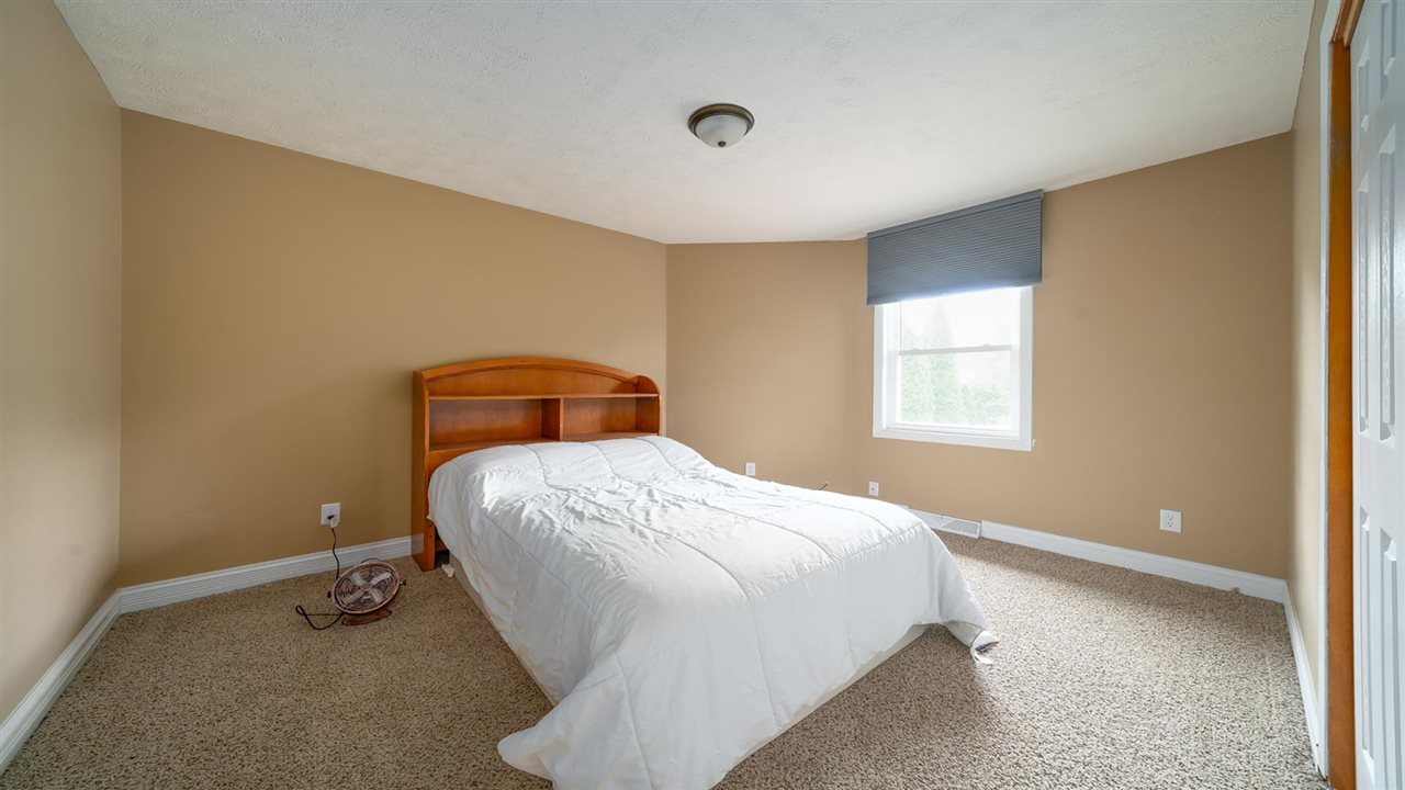 310 Pembroke Road Southwest Poplar Grove, IL 61065 - Photo 22 of 27 a bedroom with a bed and window