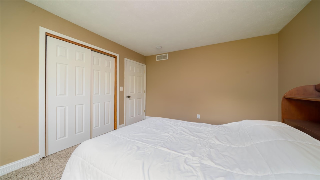 310 Pembroke Road Southwest Poplar Grove, IL 61065 - Photo 23 of 27 a bedroom with a bed and a mirror