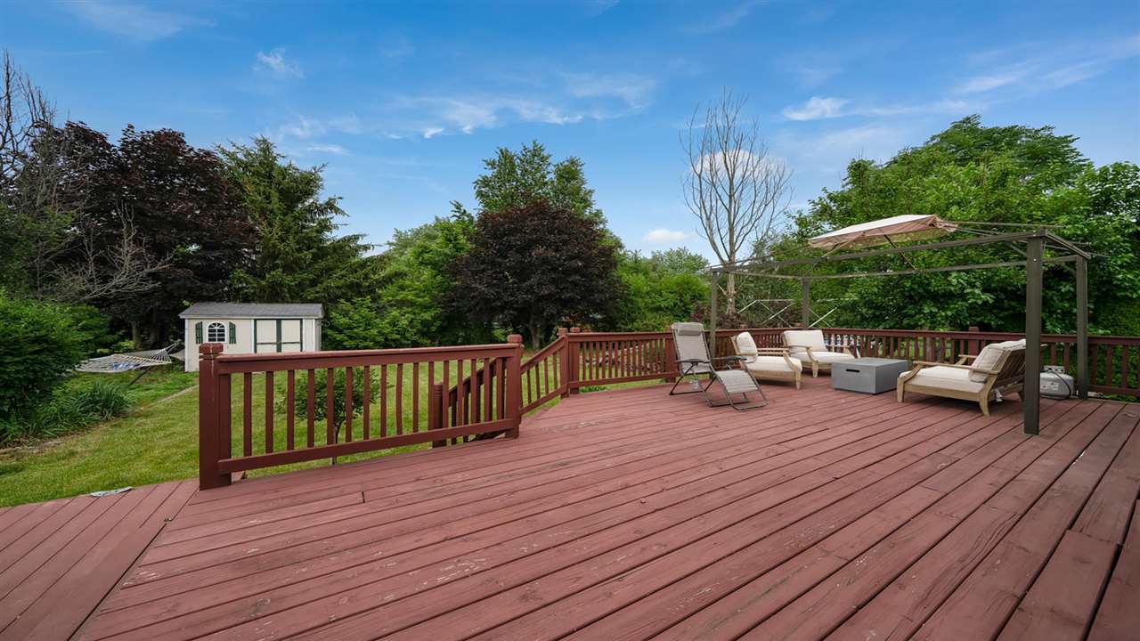 310 Pembroke Road Southwest Poplar Grove, IL 61065 - Photo 24 of 27 a view of a deck with couches wooden floor and fence