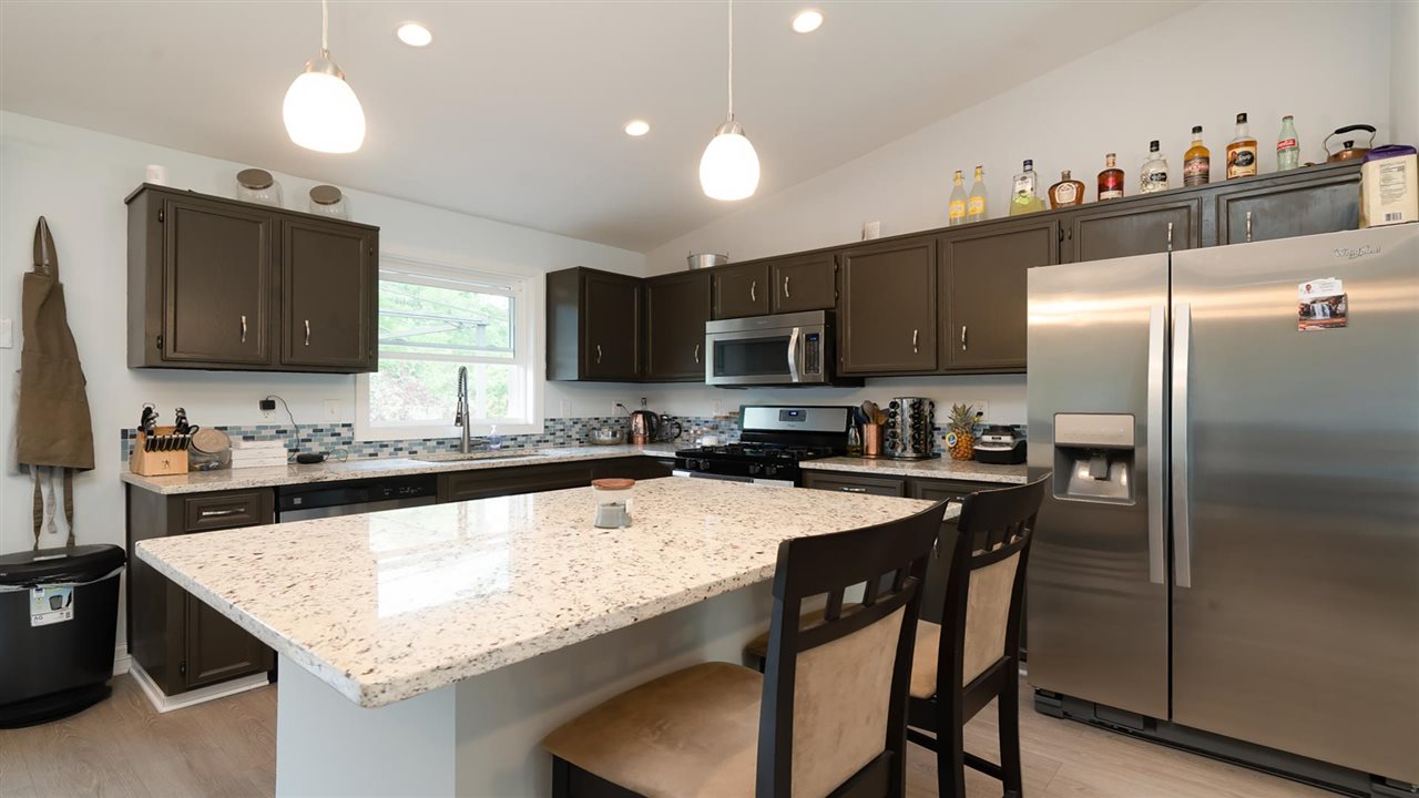 310 Pembroke Road Southwest Poplar Grove, IL 61065 - Photo 4 of 27 a kitchen with granite countertop a sink stove and refrigerator
