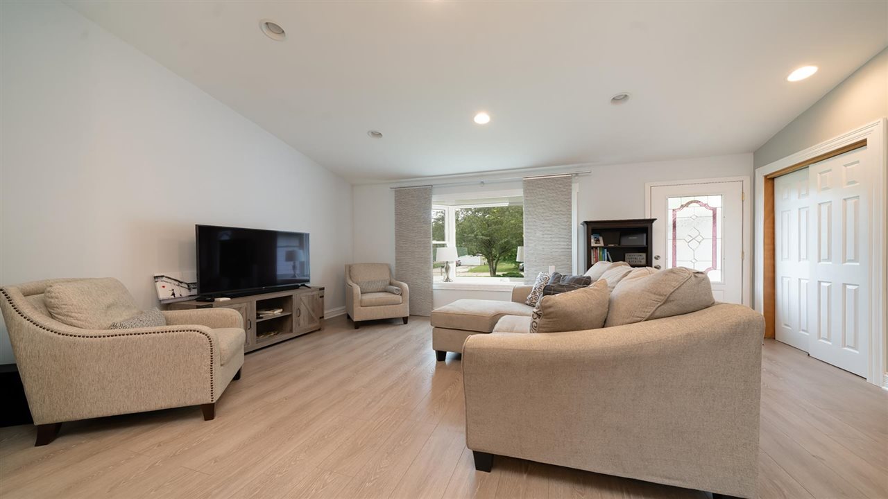 310 Pembroke Road Southwest Poplar Grove, IL 61065 - Photo 9 of 27 a living room with furniture and a flat screen tv