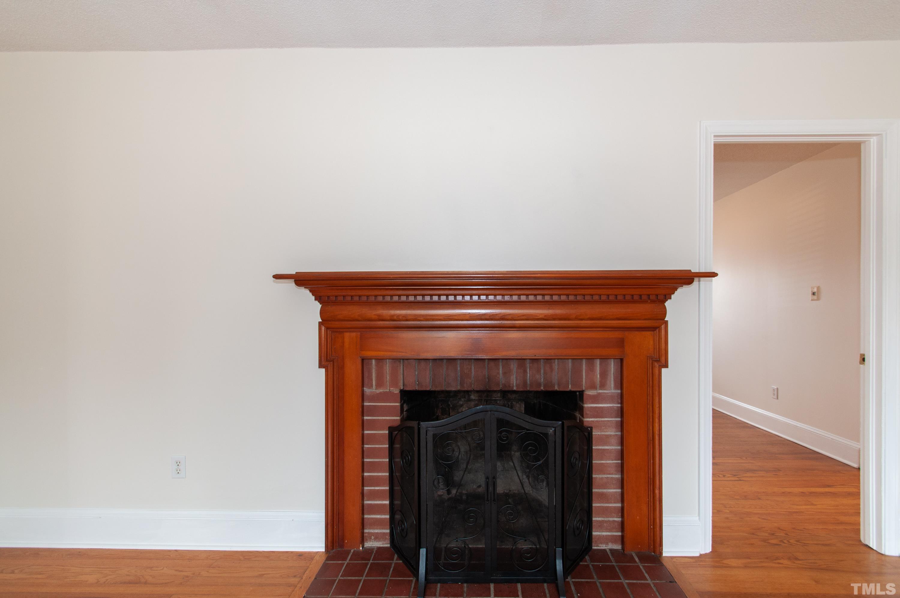 6756 Rock Quarry Road Garner, NC 27529 - Photo 4 of 33 a an empty room with wooden floor and a fireplace