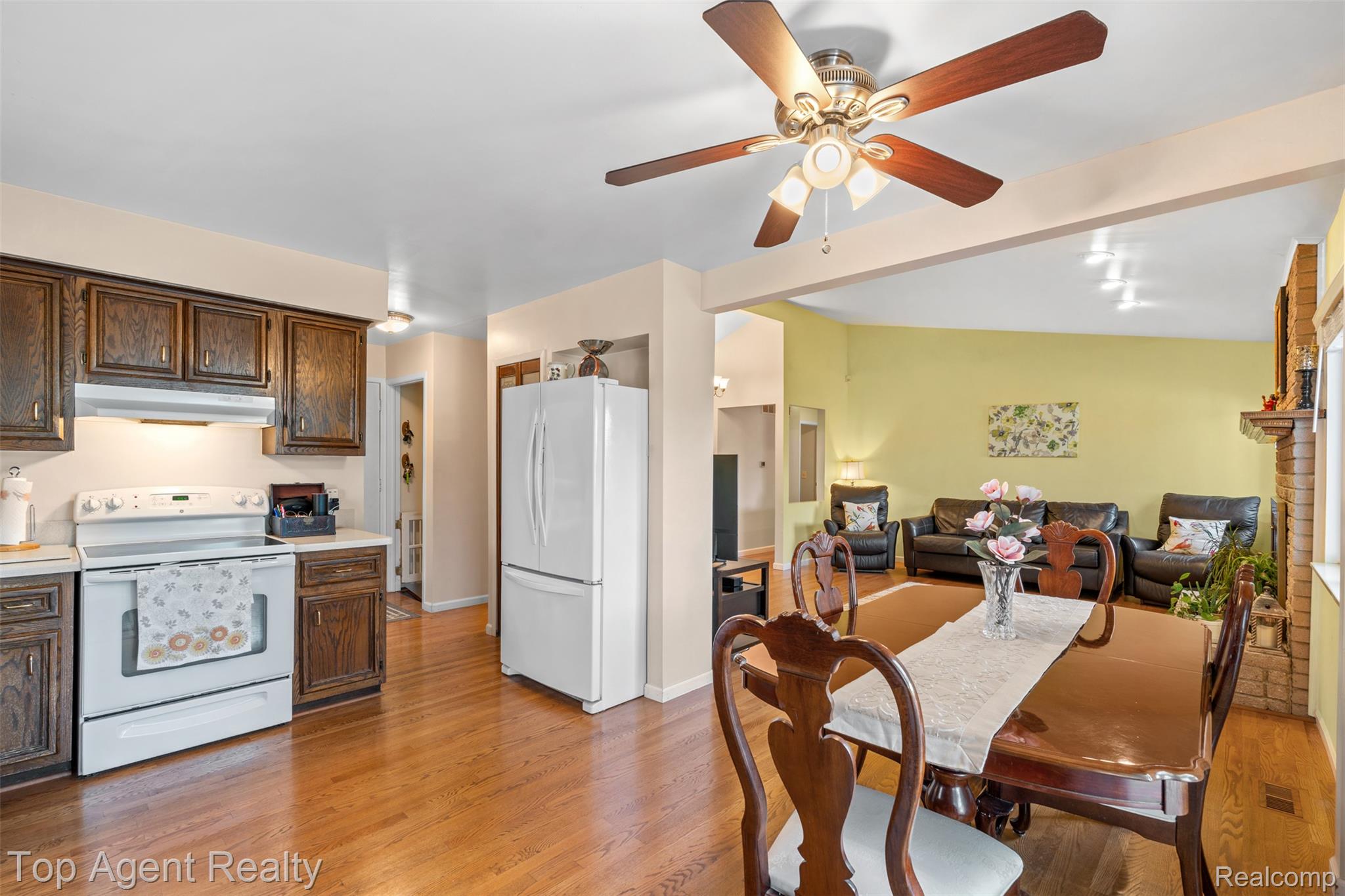 1351 Milverton Road Troy, MI 48083 - Photo 13 of 42 Kitchen featuring white appliances, light countertops, light wood finished floors, and dark brown cabinetry