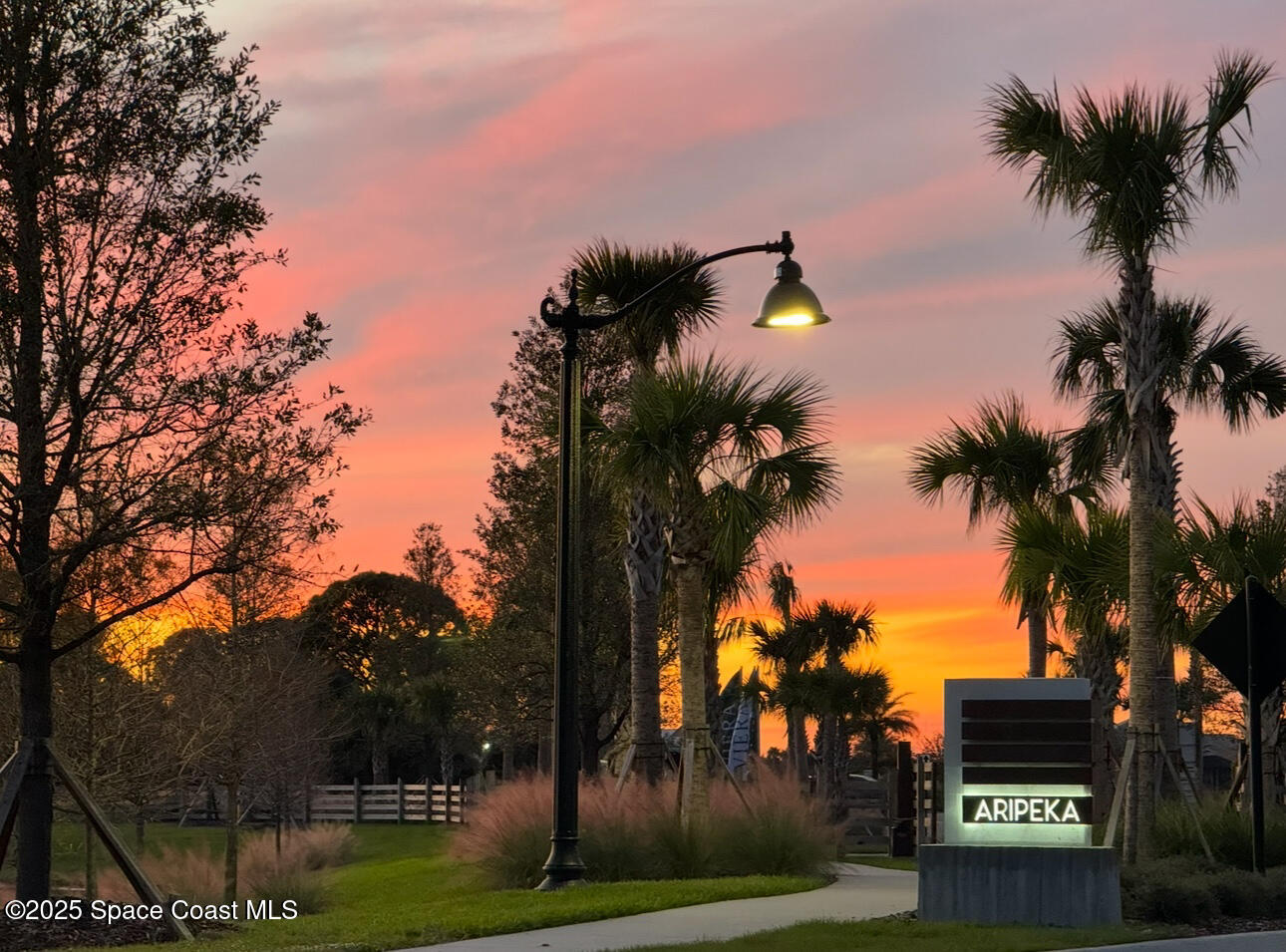 8161 Waxwing Circle Melbourne, FL 32940 - Photo 2 of 4 a view of a house with a street light and a palm tree