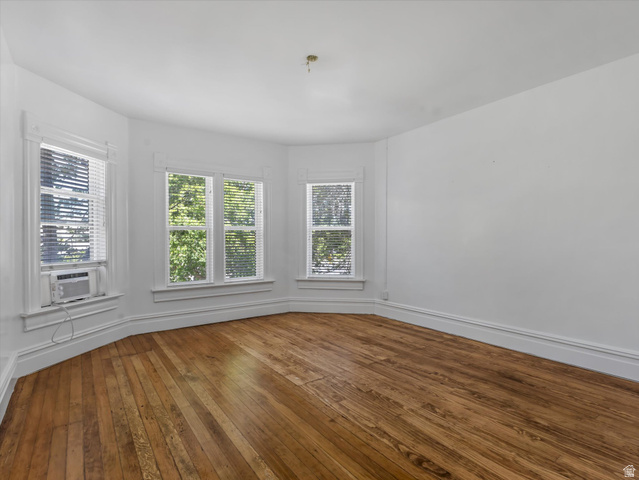 12825 South Fort Street Draper, UT 84020 - Photo 25 of 52 Hardwood flooring in a room featuring multiple windows, white baseboards, and white wall finishes