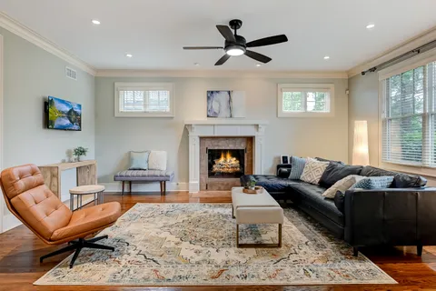 a living room with furniture a rug and a fireplace