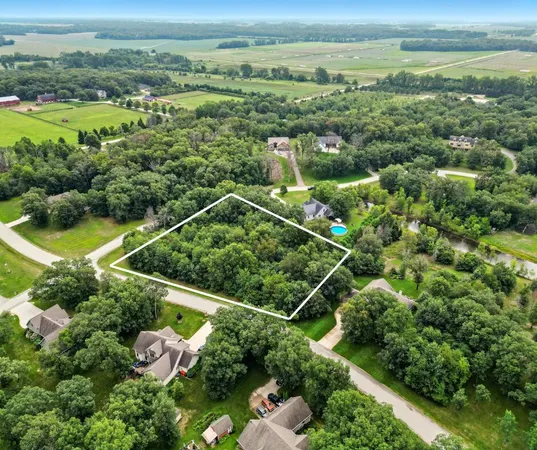 an aerial view of residential houses with outdoor space and swimming pool