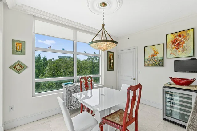 a kitchen with stainless steel appliances kitchen island granite countertop a refrigerator a stove a sink dishwasher and white cabinets with wooden floor