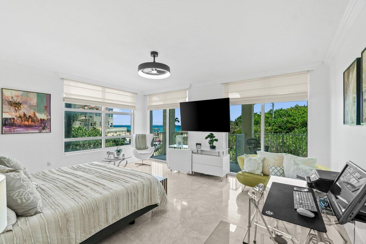 3740 South Ocean Boulevard, Unit 201 Highland Beach, FL 33487 - Photo 18 of 62 a bedroom with a bed and a flat screen tv