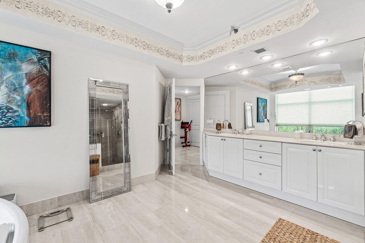 3740 South Ocean Boulevard, Unit 201 Highland Beach, FL 33487 - Photo 22 of 62 a spacious bathroom with a shower a sink and a mirror