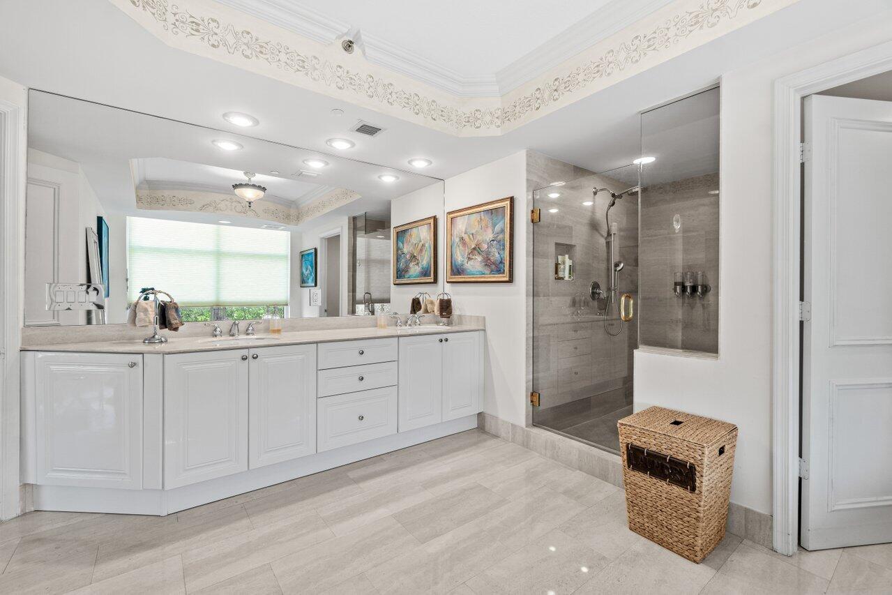 3740 South Ocean Boulevard, Unit 201 Highland Beach, FL 33487 - Photo 23 of 62 a bathroom with a sink a toilet a mirror and shower