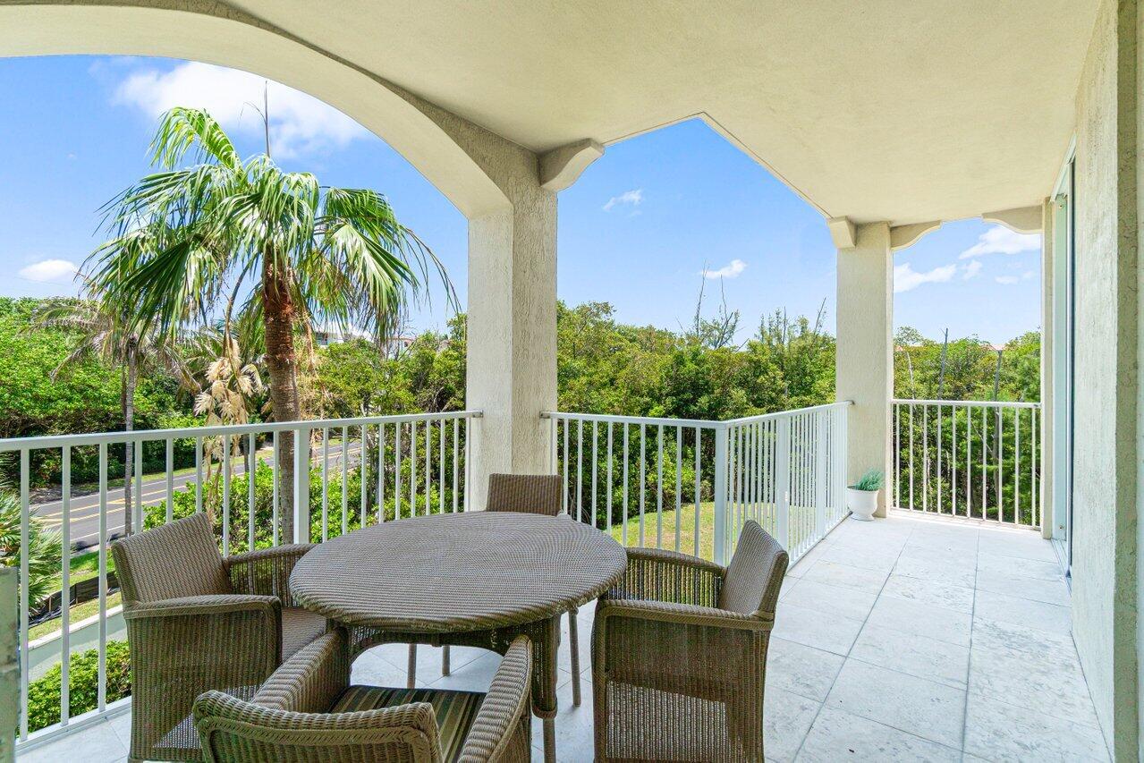 3740 South Ocean Boulevard, Unit 201 Highland Beach, FL 33487 - Photo 24 of 62 a view of a patio with couches chairs and wooden floor