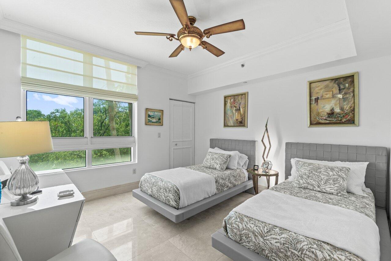 3740 South Ocean Boulevard, Unit 201 Highland Beach, FL 33487 - Photo 30 of 62 a bedroom with 2 bed and a large window