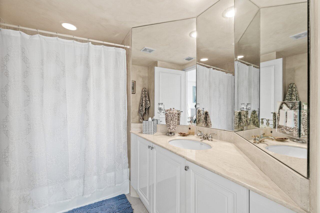 3740 South Ocean Boulevard, Unit 201 Highland Beach, FL 33487 - Photo 32 of 62 a bathroom with a double vanity sink and mirror