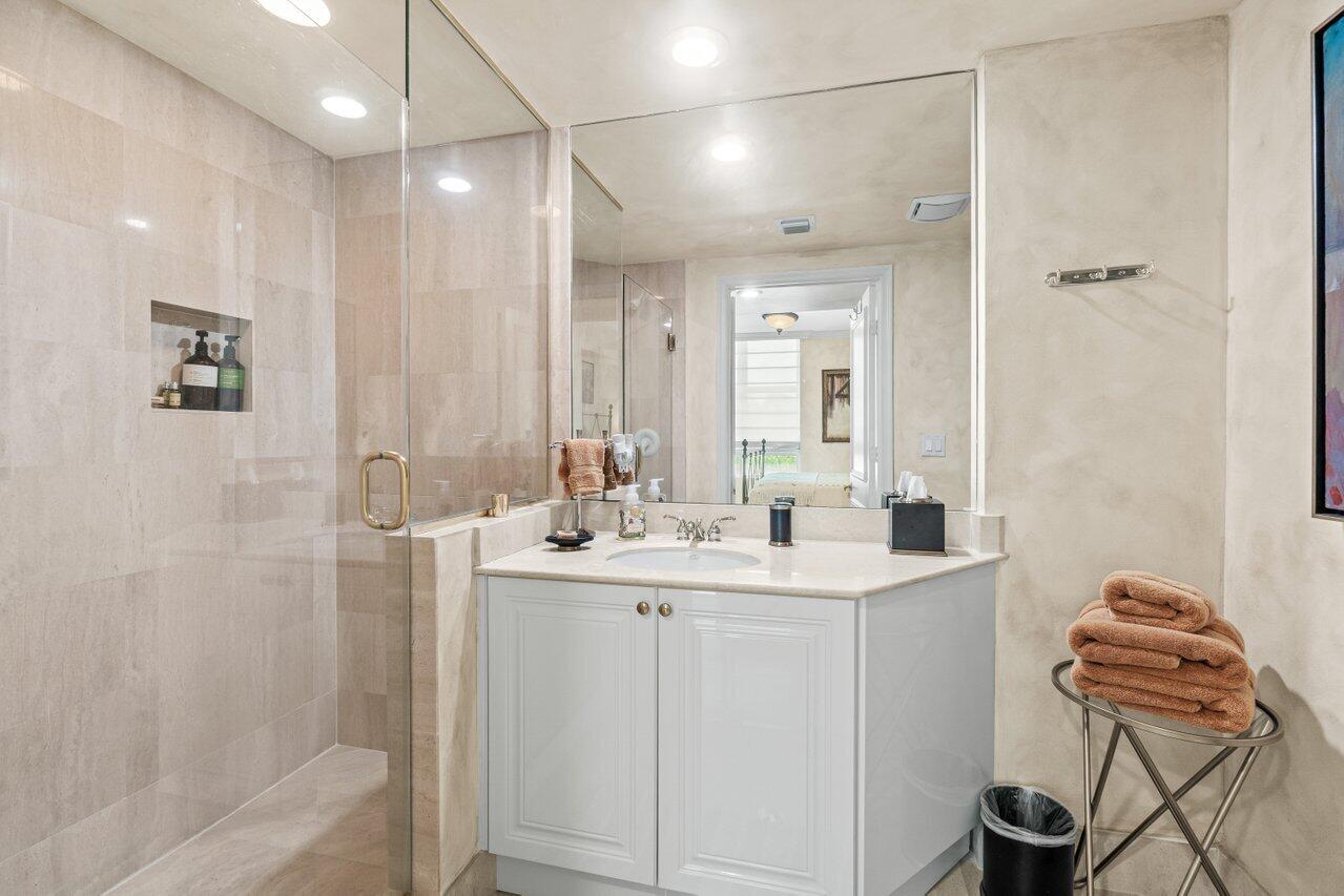 3740 South Ocean Boulevard, Unit 201 Highland Beach, FL 33487 - Photo 34 of 62 a bathroom with a double vanity sink a toilet and shower