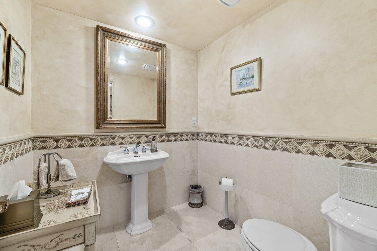 3740 South Ocean Boulevard, Unit 201 Highland Beach, FL 33487 - Photo 35 of 62 a bathroom with a sink mirror and toilet