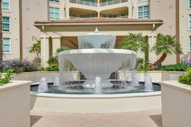 a living room with lots of furniture and view of kitchen