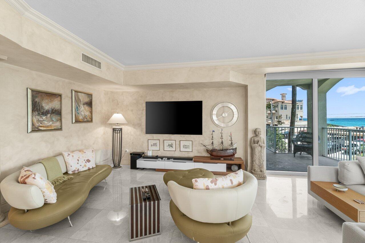 3740 South Ocean Boulevard, Unit 201 Highland Beach, FL 33487 - Photo 5 of 62 a living room with furniture and a flat screen tv