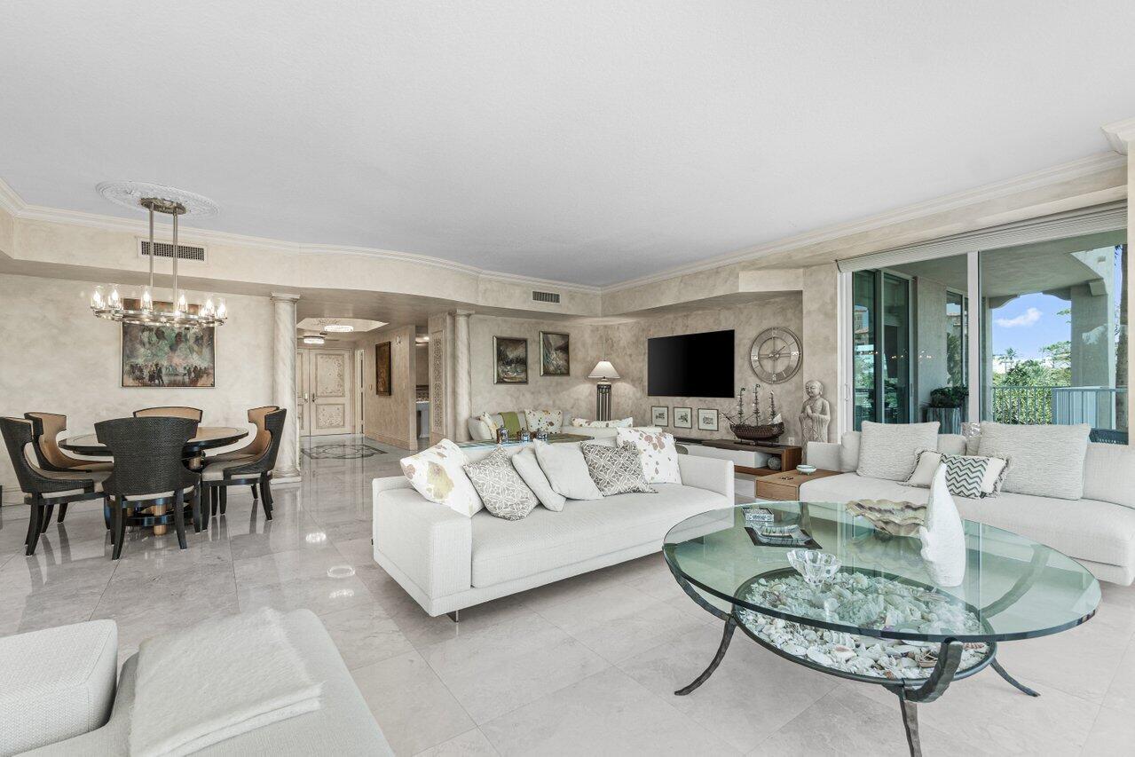 3740 South Ocean Boulevard, Unit 201 Highland Beach, FL 33487 - Photo 10 of 62 a living room with furniture a table and a large window