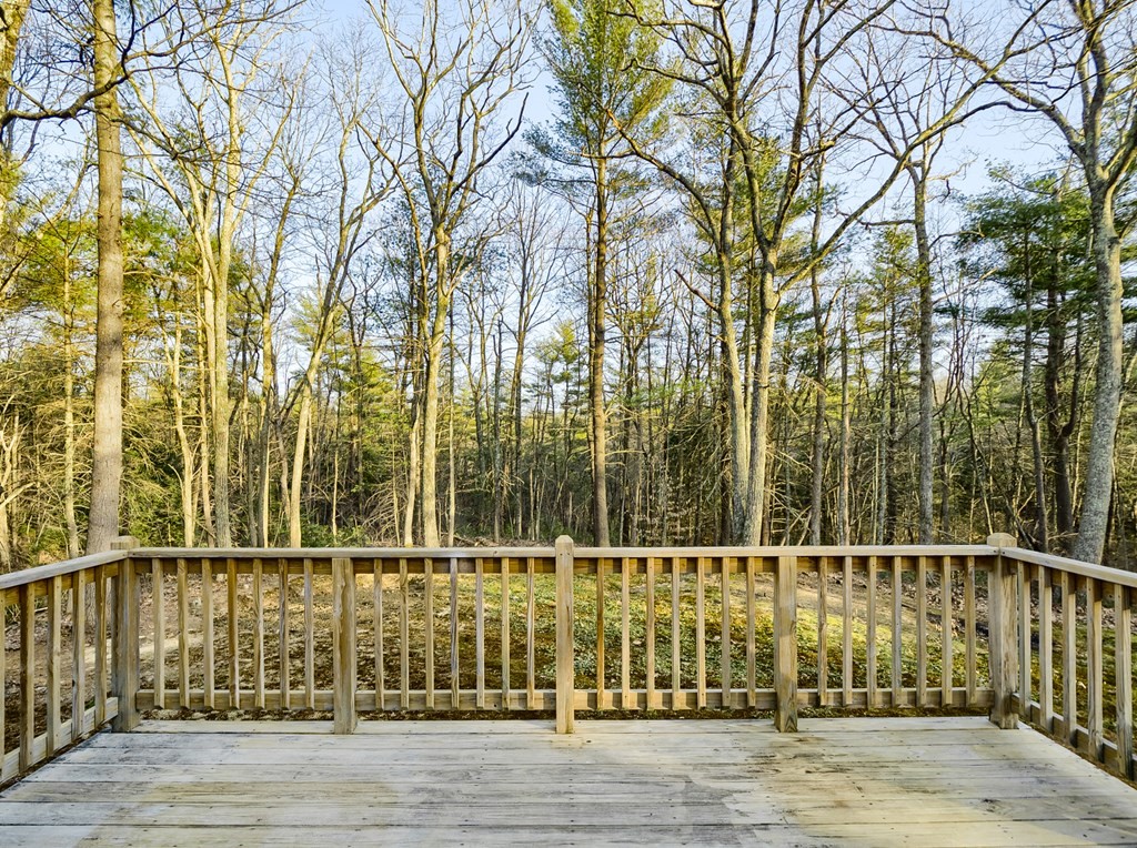 45 Pleasantdale Road Rutland, MA 01543 - Photo 27 of 29 a view of a balcony with a floor to ceiling window and wooden fence