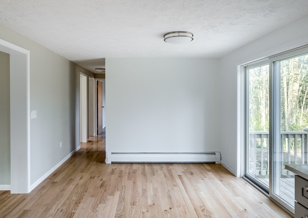 45 Pleasantdale Road Rutland, MA 01543 - Photo 7 of 29 an empty room with wooden floor and windows