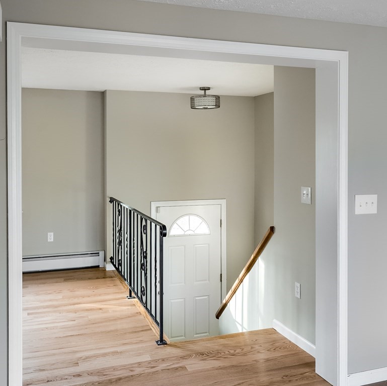 45 Pleasantdale Road Rutland, MA 01543 - Photo 8 of 29 a view of a hallway with wooden floor and staircase