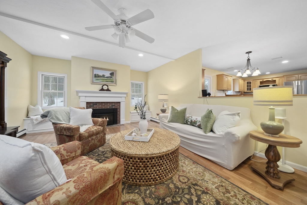 86 Telegraph Hill Road Marshfield, MA 02050 - Photo 11 of 42 a living room with furniture a fireplace and a chandelier