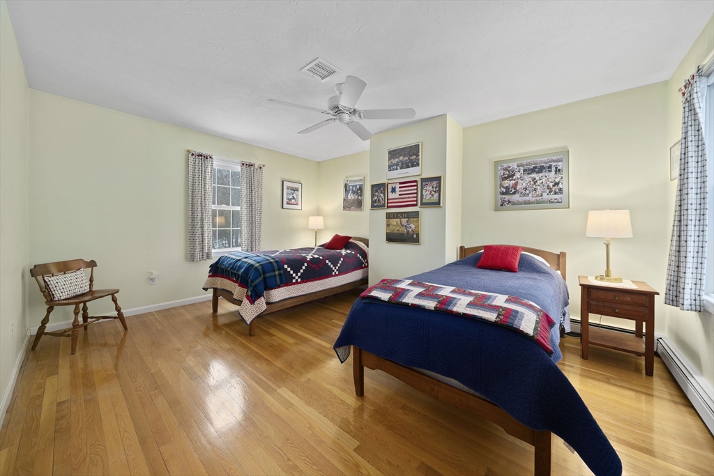 86 Telegraph Hill Road Marshfield, MA 02050 - Photo 20 of 42 a bedroom with a bed and a chandelier