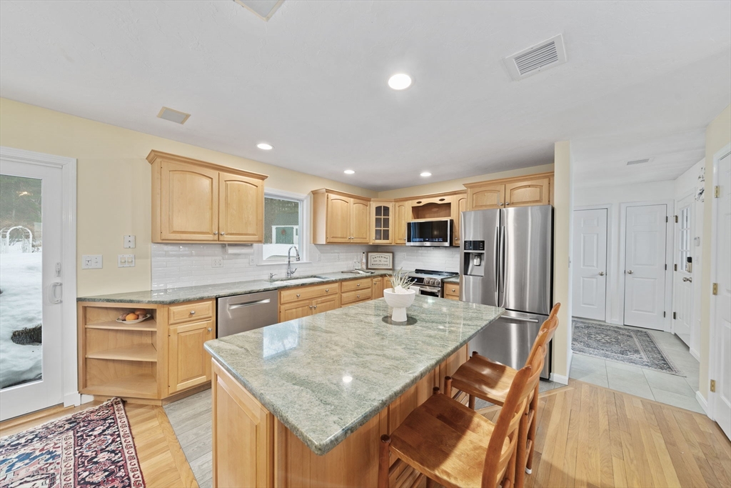 86 Telegraph Hill Road Marshfield, MA 02050 - Photo 6 of 42 a kitchen with stainless steel appliances granite countertop a sink and a refrigerator