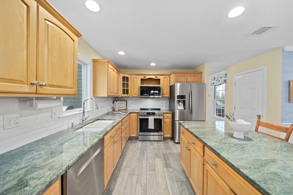 86 Telegraph Hill Road Marshfield, MA 02050 - Photo 7 of 42 a large kitchen with stainless steel appliances granite countertop a large counter top a stove a sink and a refrigerator