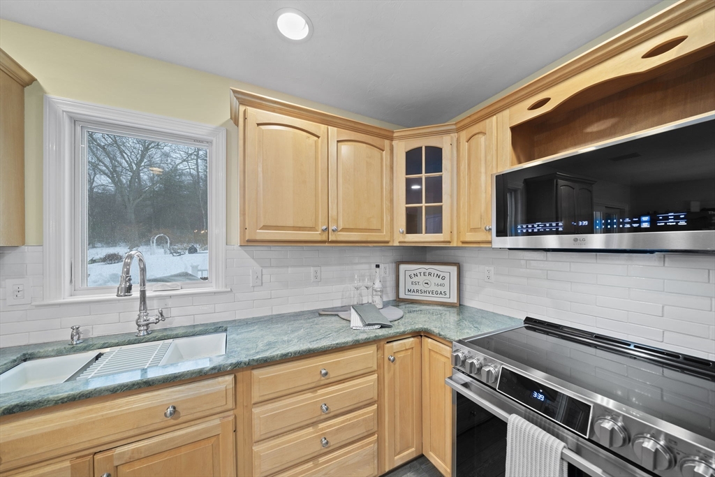 86 Telegraph Hill Road Marshfield, MA 02050 - Photo 9 of 42 a kitchen with stainless steel appliances granite countertop a sink and a stove