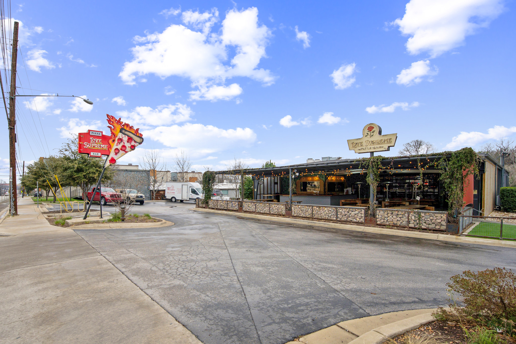 2827 Manor Road, Unit 3104 Austin, TX 78722 - Photo 28 of 30 A commercial property featuring an inviting outdoor seating area and distinct signage.