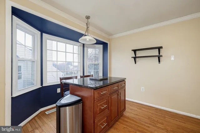 a kitchen with stainless steel appliances granite countertop a stove and a window