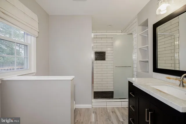 a view of bathroom with a sink and mirror