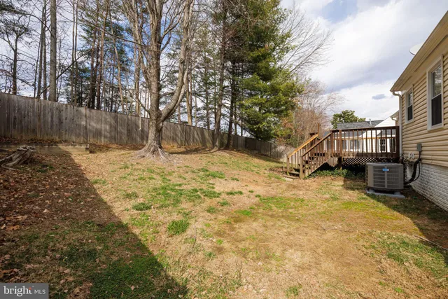 a yellow house with trees in front of it