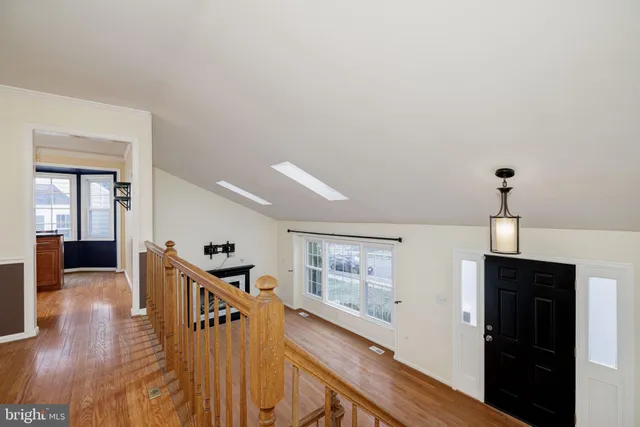a view of a hallway with the wooden floor and staircase