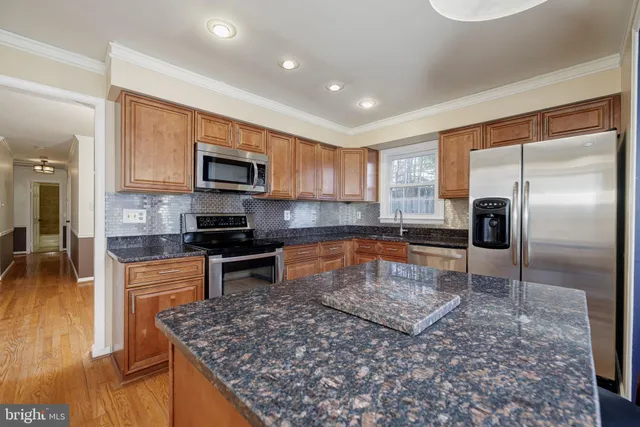 a kitchen with a refrigerator sink and microwave
