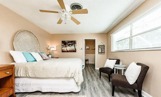 a bedroom with a large bed and a chandelier