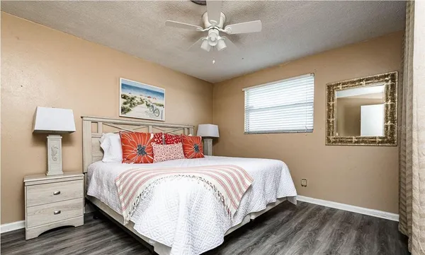 a bedroom with a large bed and a window