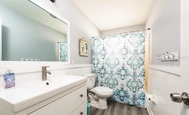 a bathroom with a sink toilet and shower