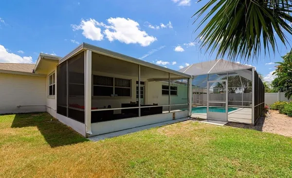a view of a house with a backyard and a patio