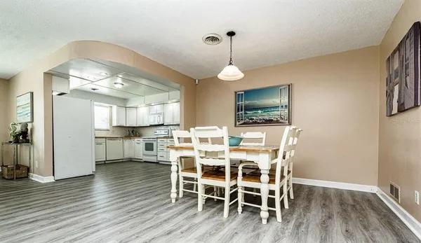 a view of a dining room with furniture and wooden floor
