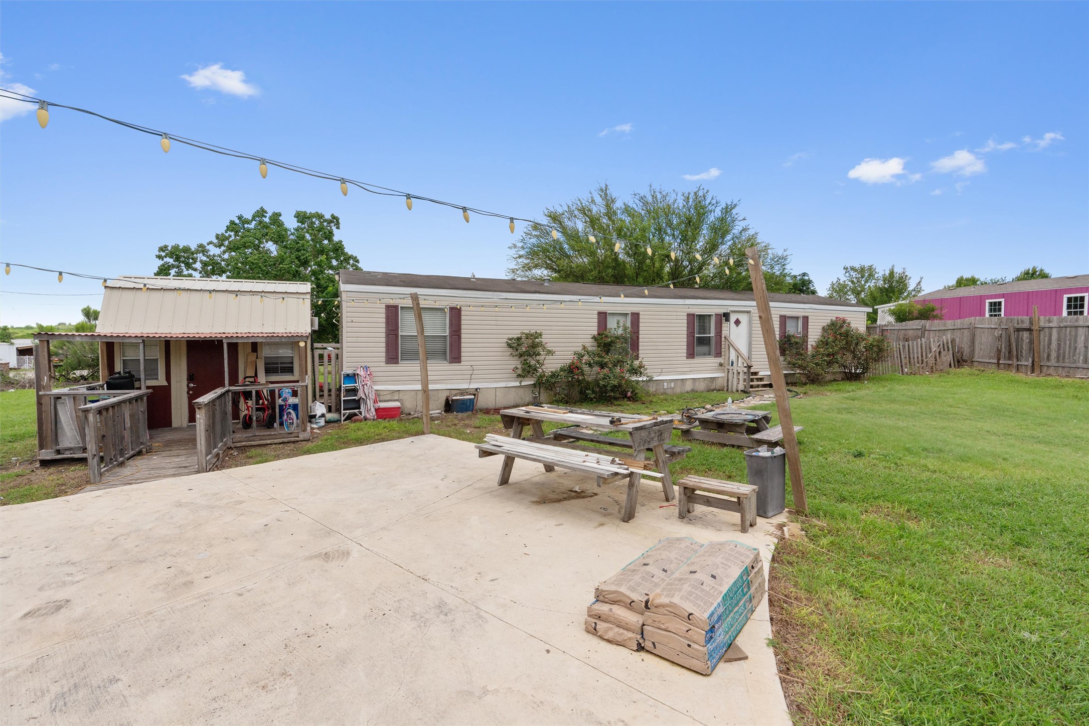 218 Boxcar Path Kyle, TX 78640 - Photo 19 of 21 A spacious yard and concrete patio provide ample outdoor living area for this property.
