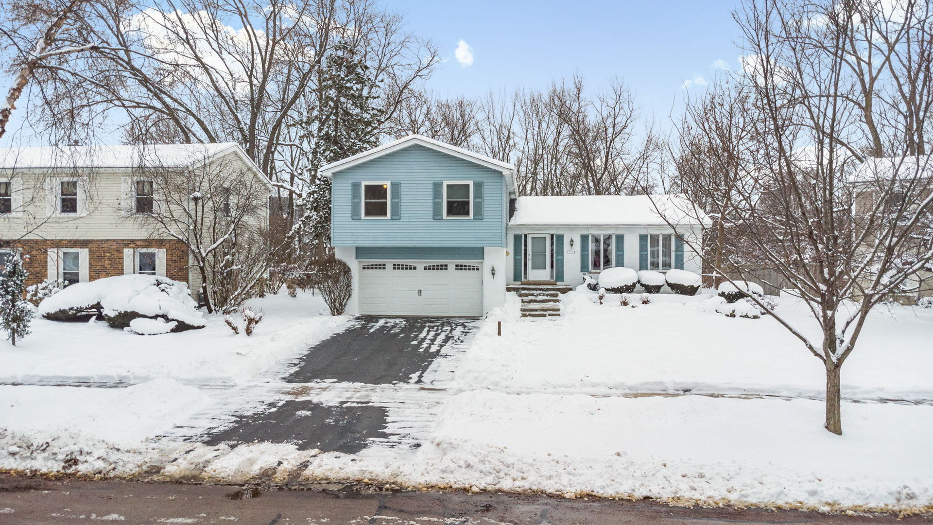 710 Morris Court Lombard, IL 60148 - Photo 2 of 2 a front view of a house with a yard covered in snow