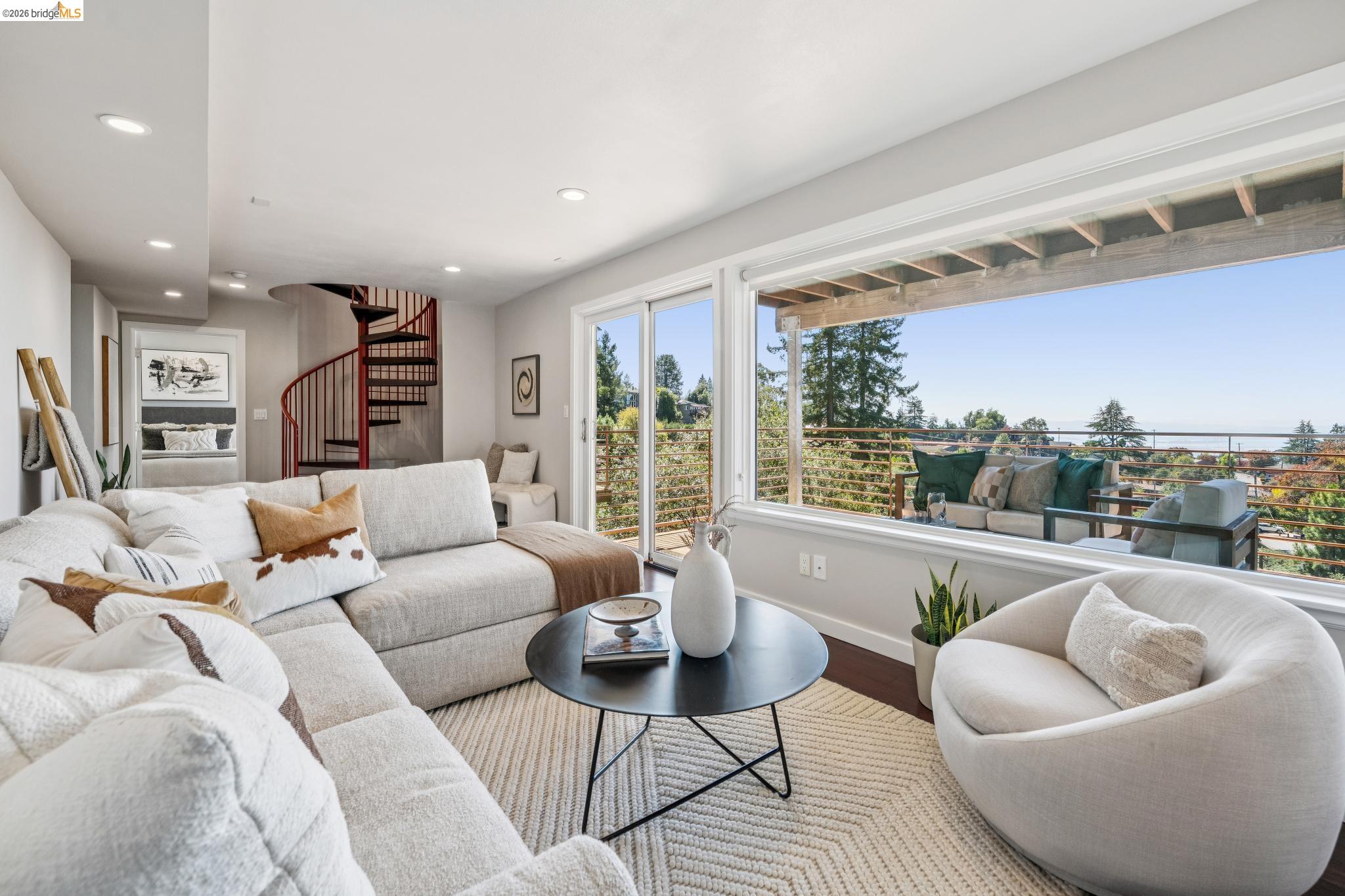 1394 Queens Road Berkeley, CA 94708 - Photo 40 of 63 Expansive window wall with outdoor scenery, recessed lighting, hard-surface flooring, and a spiral staircase