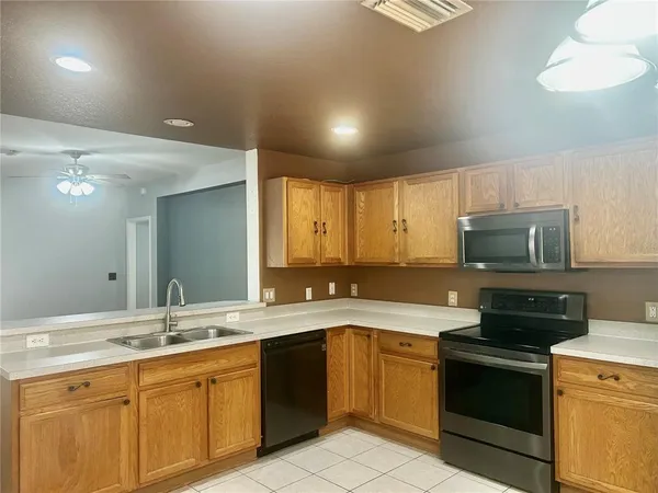 a kitchen with a sink stove and microwave