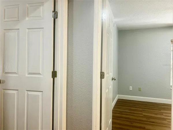 a view of a room with wooden floor